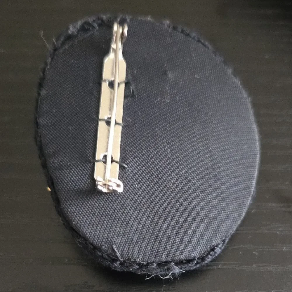 Artistic Face Brooch with Gold and Black Accents